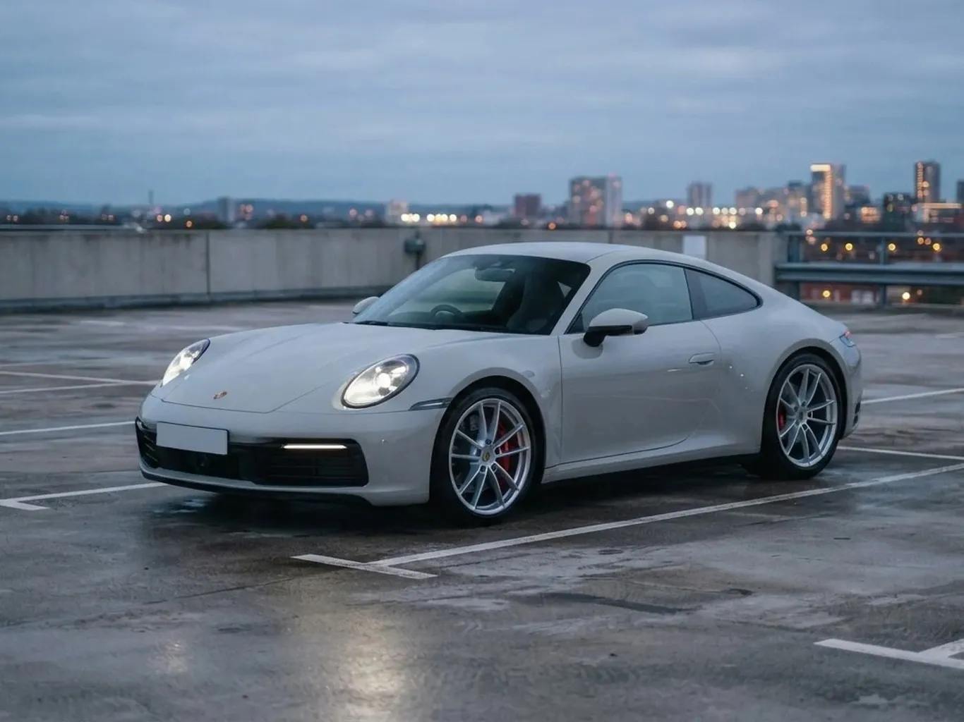 A white Porsche 911 and the same car built by Tuner in gloss black: Stock